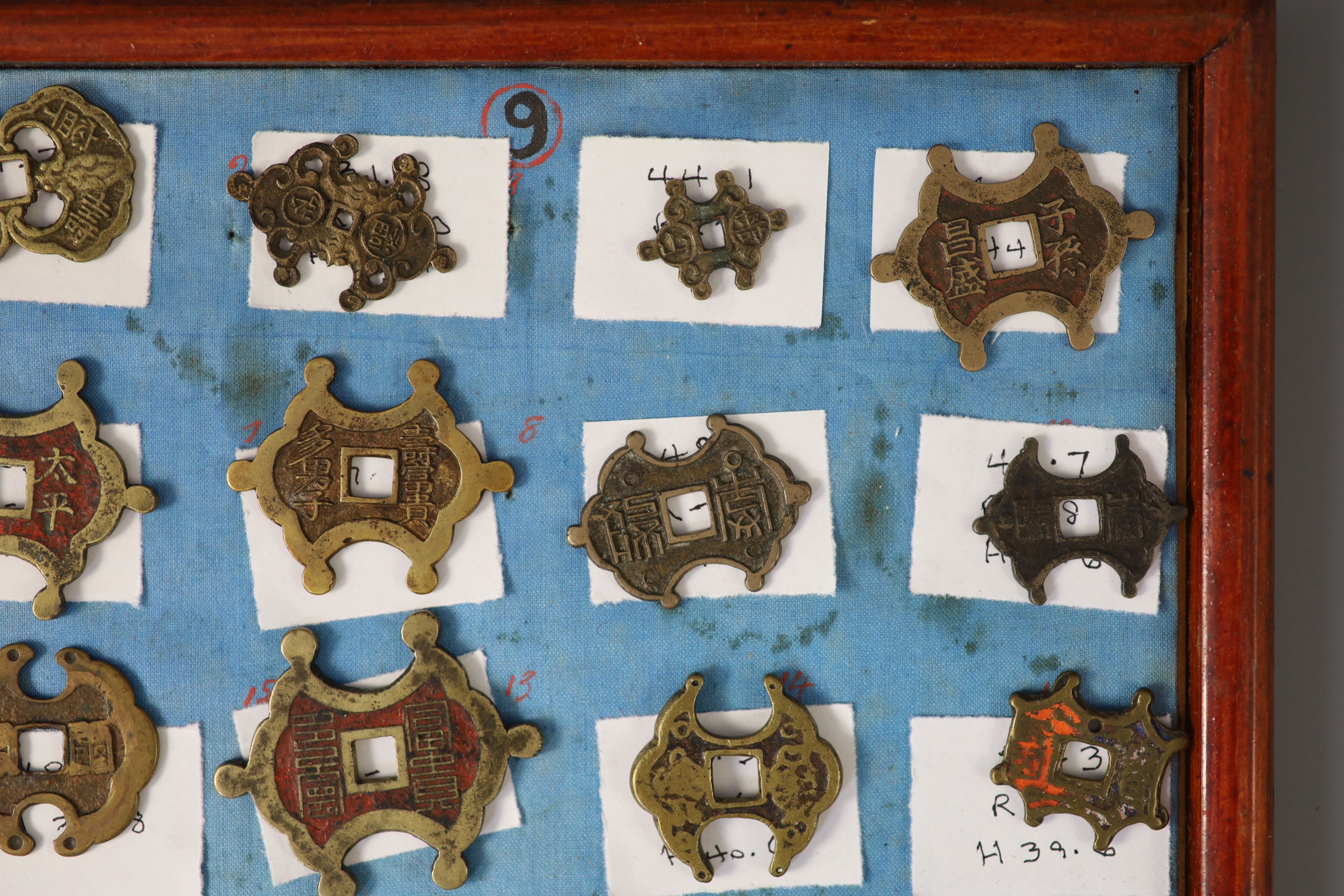 A group of 99 Korean bronze and metal amulets or charms, 19th/20th century
